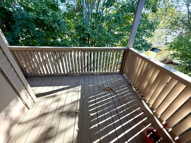 a view of balcony with wooden floor