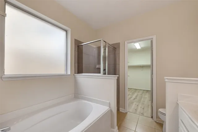 a bathroom with a bathtub and a shower