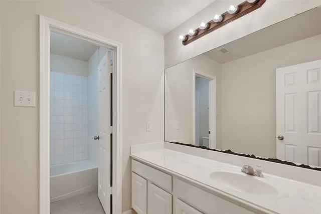 a bathroom with a bathtub and a sink