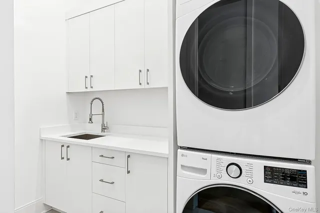 a utility room with sink dryer and washer