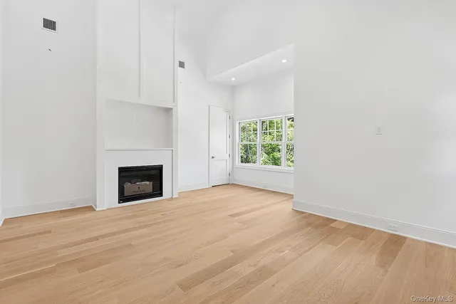 a view of empty room with a fireplace