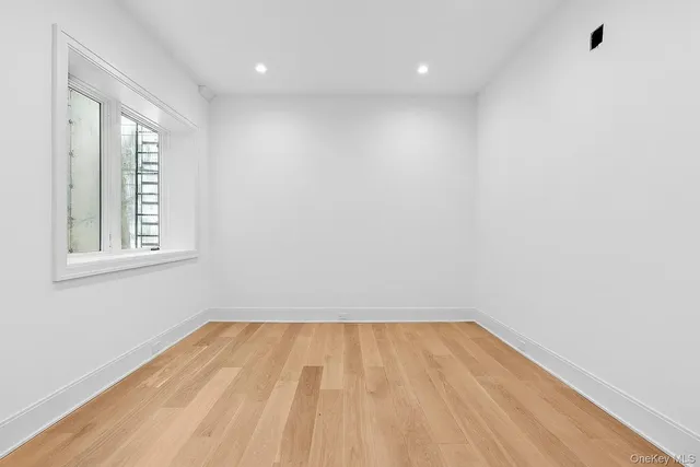 a view of room with window and wooden floor
