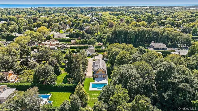 an aerial view of a residential houses with outdoor space and street view