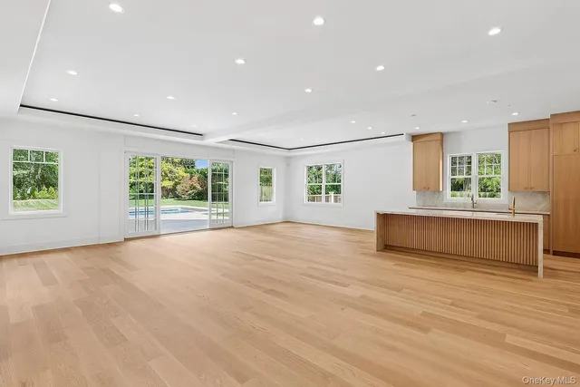 an empty room with windows and entrance