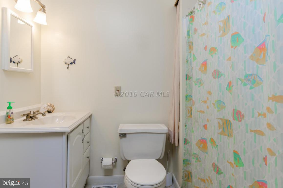 13 Capetown Road Ocean Pines, MD 21811 - Photo 15 of 46 a bathroom with a sink toilet and a mirror