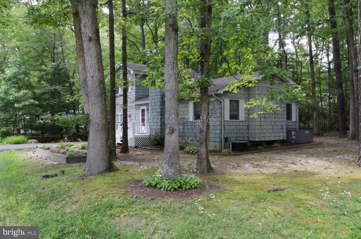 13 Capetown Road Ocean Pines, MD 21811 - Photo 24 of 46 a backyard of a house with lots of green space and fountain