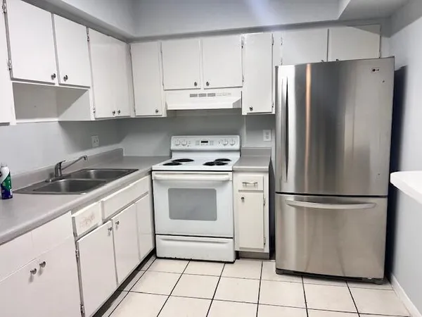 a kitchen with cabinets stainless steel appliances and a sink