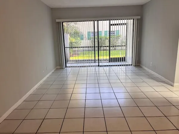 a view of an empty room and a window