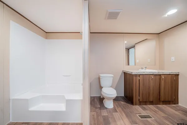 a bathroom with a toilet a sink and a shower
