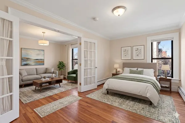 a bedroom with a bed and wooden floor