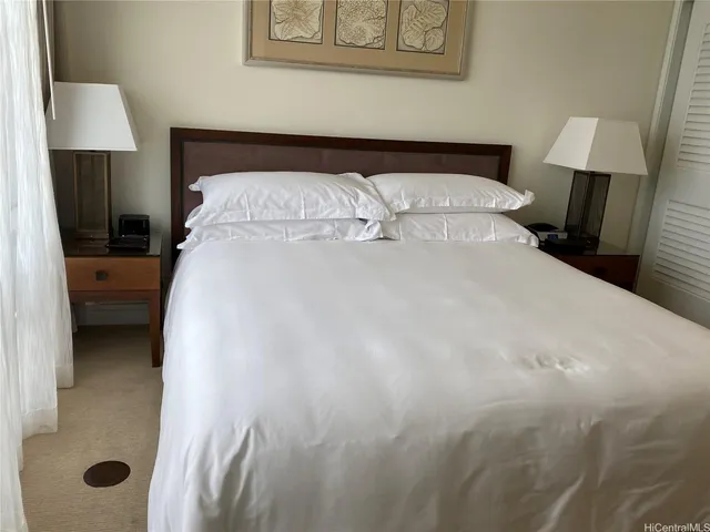 a bedroom with a bed and a lamp