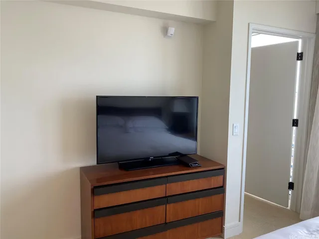 a living room with a bed and a mirror