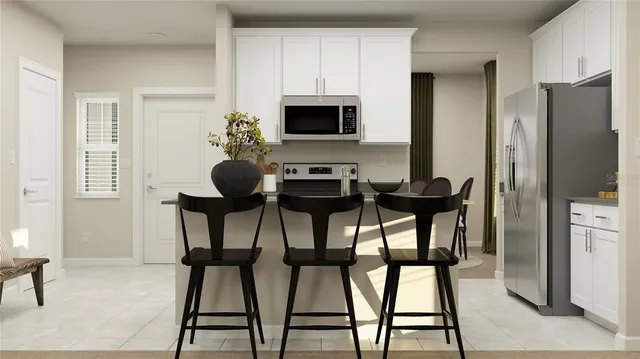 a view of a dining room with furniture and a refrigerator