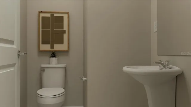 a bathroom with a sink a toilet and a mirror