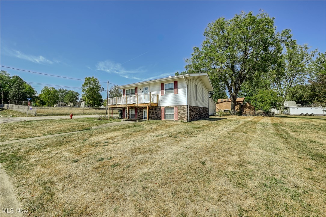 2359 Sanitarium Road Lakemore, OH 44250 - Photo 6 of 29 View of front facade featuring stone siding and a wooden deck