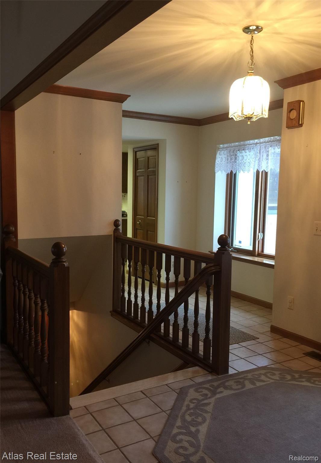 9950 Misty Ridge Circle Clarkston, MI 48348 - Photo 19 of 50 Natural wood balustrade to basement