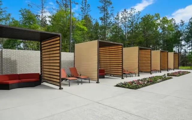 a view of backyard with barbeque grill and wooden fence