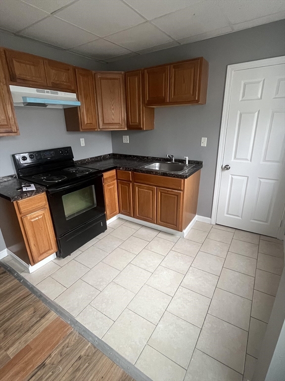 422 County Street Fall River, MA 02723 - Photo 11 of 25 a kitchen with granite countertop a stove top oven a sink dishwasher and granite countertops