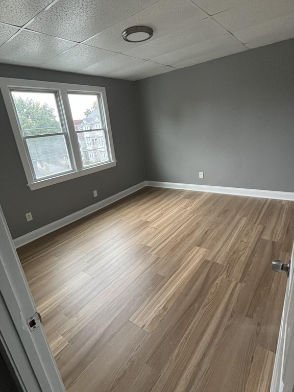 422 County Street Fall River, MA 02723 - Photo 19 of 25 an empty room with wooden floor and windows