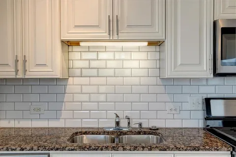 a kitchen with a sink and cabinets