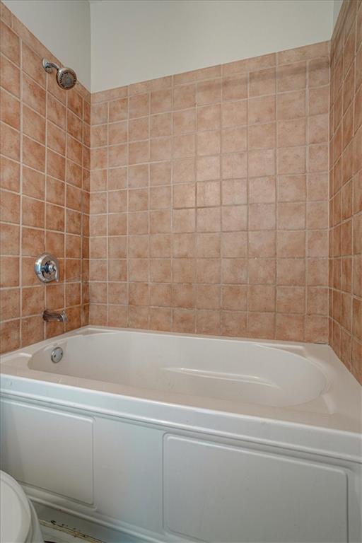 238 Walker Street Southwest, Unit 32 Atlanta, GA 30313 - Photo 8 of 17 a bathroom with a bathtub and shower