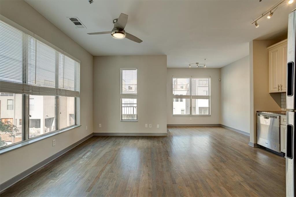 238 Walker Street Southwest, Unit 32 Atlanta, GA 30313 - Photo 9 of 17 a view of an empty room with a window and wooden floor