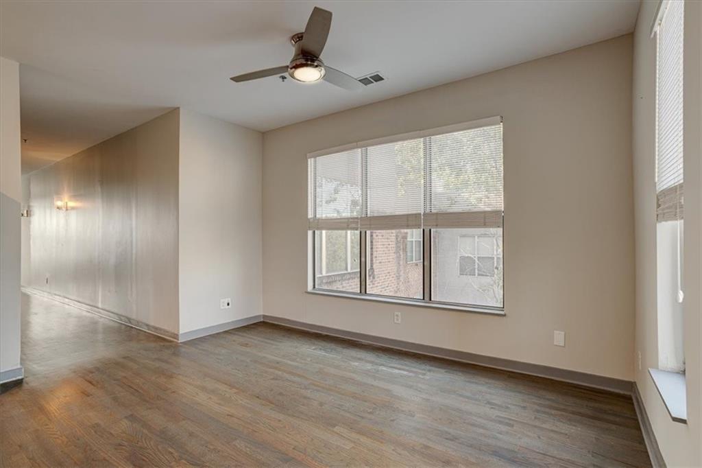 238 Walker Street Southwest, Unit 32 Atlanta, GA 30313 - Photo 10 of 17 a view of an empty room with wooden floor and a window