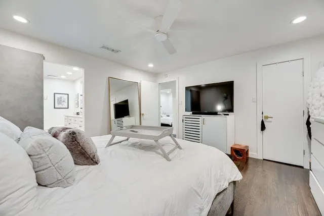 a bedroom with a bed and a flat screen tv