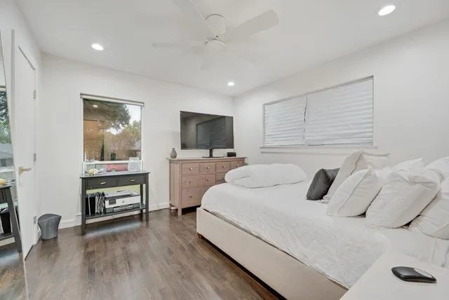 a bedroom with a bed and a flat screen tv