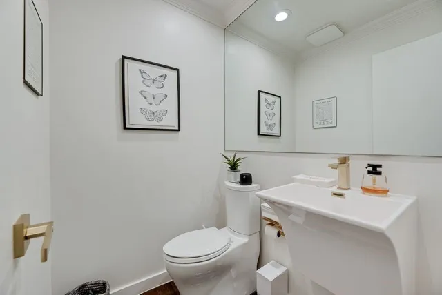 a bathroom with a toilet sink and mirror