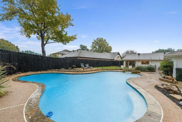 a view of a swimming pool and lounge chair