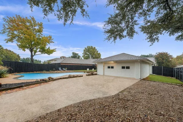 a view of large house with a yard and large tree