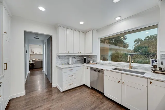 a kitchen with sink cabinets and wooden floor