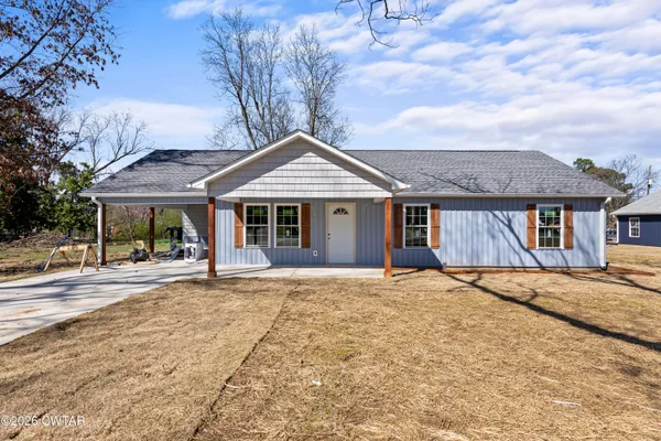 a front view of a house with a garden and entryway