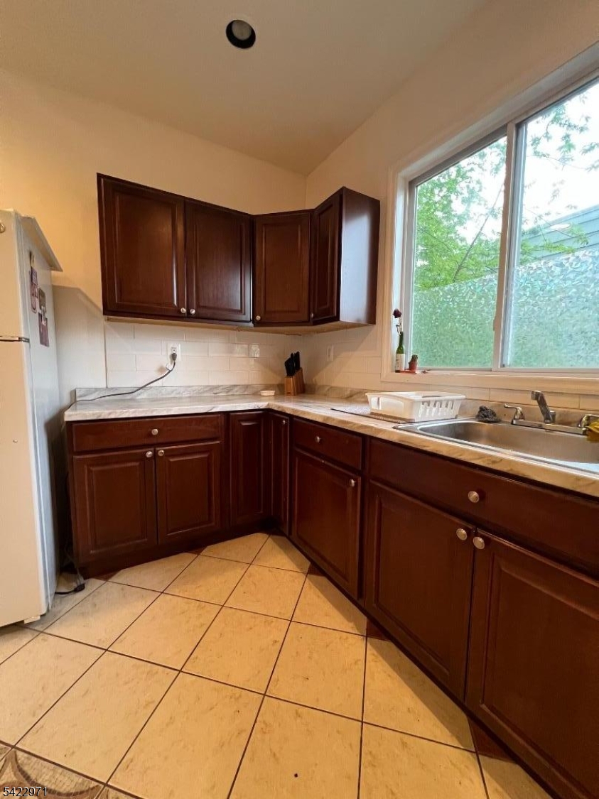 5 Timothy Street, Unit 4 Paterson, NJ 07503 - Photo 12 of 16 a kitchen with a sink a window and cabinets