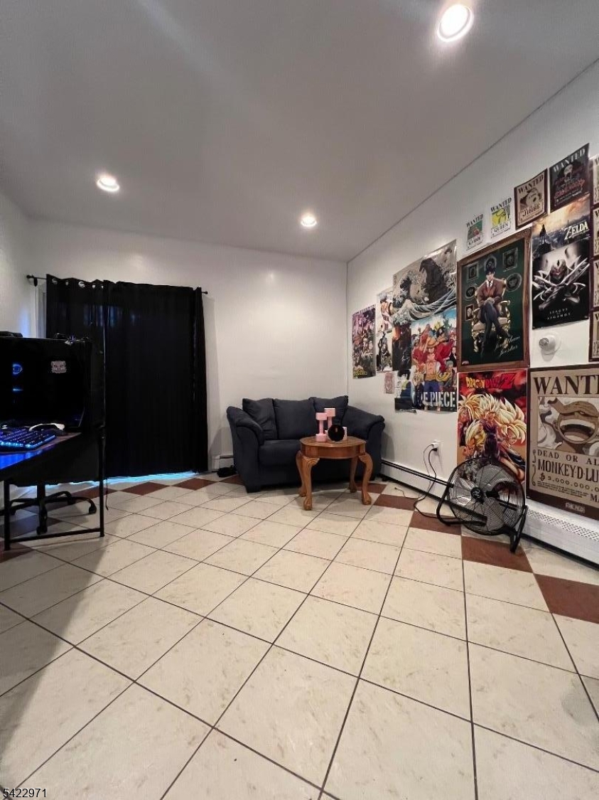 5 Timothy Street, Unit 4 Paterson, NJ 07503 - Photo 13 of 16 a living room with furniture and a flat screen tv