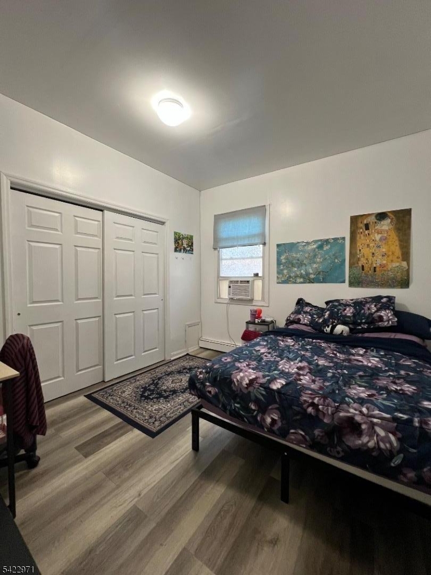 5 Timothy Street, Unit 4 Paterson, NJ 07503 - Photo 16 of 16 a large bed sitting in a spacious bedroom next to a window