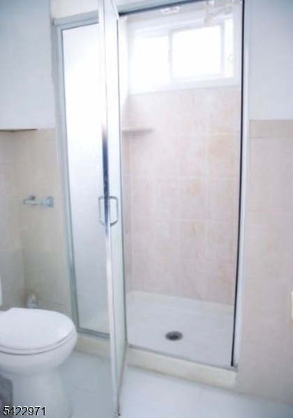 5 Timothy Street, Unit 4 Paterson, NJ 07503 - Photo 7 of 16 a bathroom with a shower and a toilet