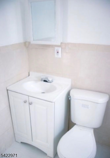 5 Timothy Street, Unit 4 Paterson, NJ 07503 - Photo 8 of 16 a white toilet sitting next to a white sink