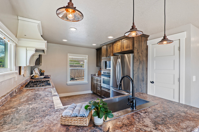 115 East 1600th Street North Santaquin, UT 84655 - Photo 9 of 52 Kitchen featuring wood-finish cabinetry, stainless steel appliances, a gas cooktop, and a built-in oven