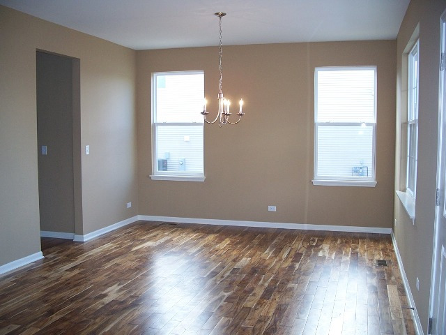 2694 Reedgrass Way Wauconda, IL 60084 - Photo 3 of 12 an empty room with wooden floor and windows