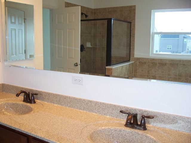 2694 Reedgrass Way Wauconda, IL 60084 - Photo 6 of 12 a bathroom with a granite countertop sink and a mirror