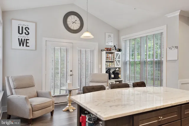 a view of a livingroom with furniture and a large window
