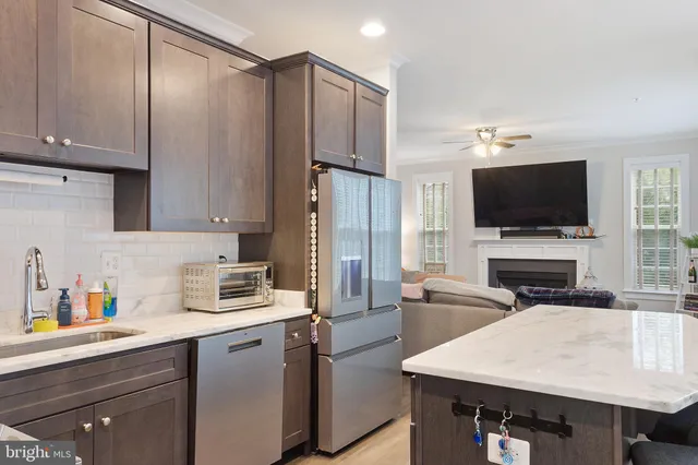 a kitchen with stainless steel appliances a stove refrigerator sink and cabinets