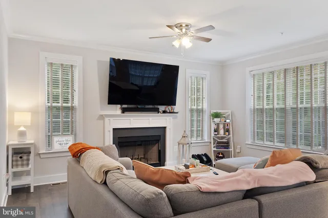 a living room with furniture a fireplace and a flat screen tv