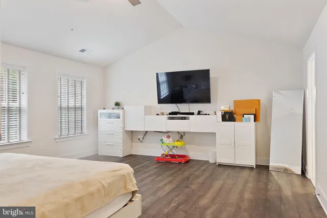 a bedroom with a bed and flat screen tv