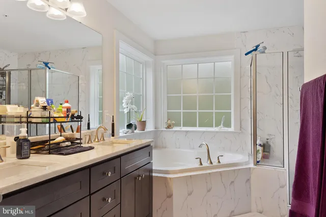 a bathroom with double vanity sinks and a bathtub