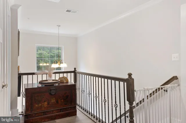 a view of a hallway to a livingroom with furniture