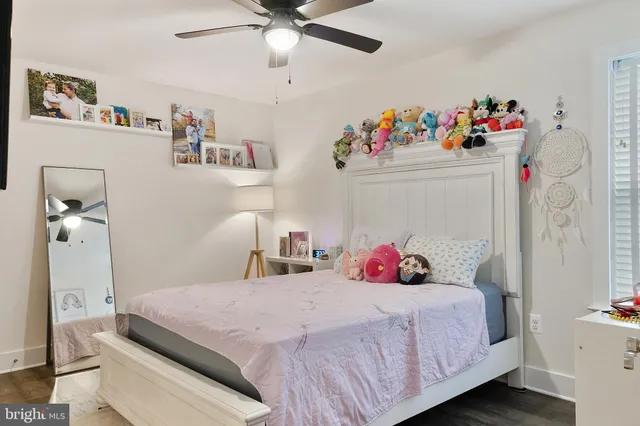 a bedroom with bed and wooden floor