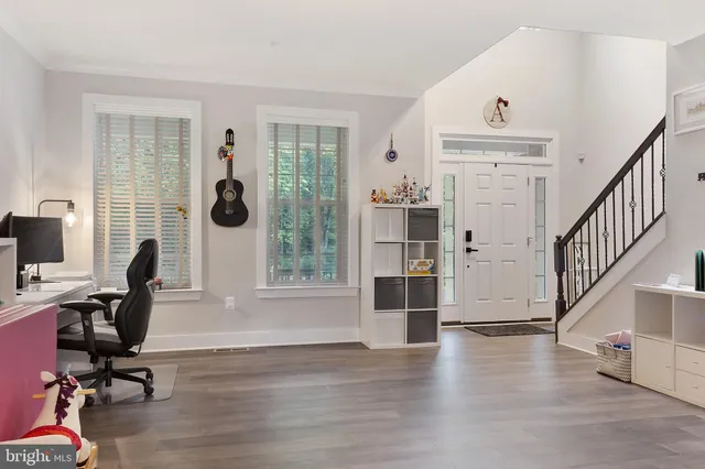 a view of livingroom with workspace and a window